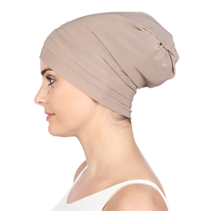 Detailed side view of pleated khaki turban cap showing soft texture and layered fabric folds