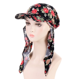 Detail of floral headscarf hat with sun brim and long straps on a mannequin head