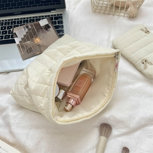 Quilted cream cosmetic bag featuring rabbit embroidery and large capacity storage detail