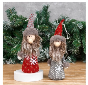 Close-up of red and grey Christmas gnome dolls with knit hats and sequin snowflakes