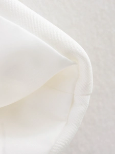 Close-up of white twill fabric texture and durable stitching on casual women's vest