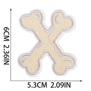 Detailed view of bone-shaped Halloween embroidery patch with size measurements in inches