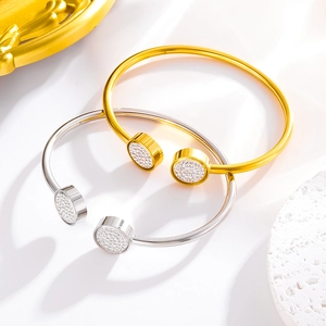 Macro detail of open-end bangle featuring sparkling pave rhinestones and round gold plating