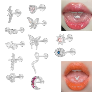Macro detail of silver surgical steel labret studs with butterfly and moon pendants