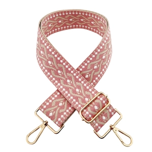Close-up of bohemian style woven 5cm wide bag strap with pink floral embroidery
