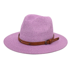 Detail of purple woven straw Panama hat featuring a brown leather band and metallic buckle