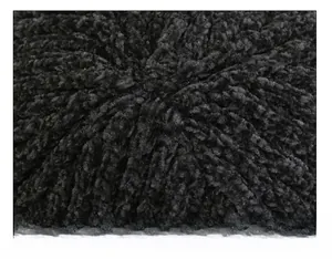 Close-up of precise cap suture technique and black knitted fabric on winter beanie
