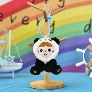 Detail view of a cute plush doll keychain wearing a fuzzy panda costume pendant charm