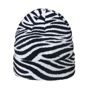 Close-up of zebra pattern knitted beanie showing soft fabric texture and cuffed design