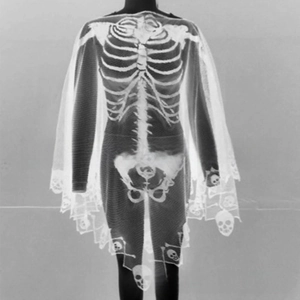 Detail of Halloween white skeleton print shawl showing bone structure on mesh fabric