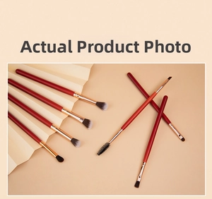 Macro detail of 7-piece makeup brush set with dark red handles and rose gold ferrules