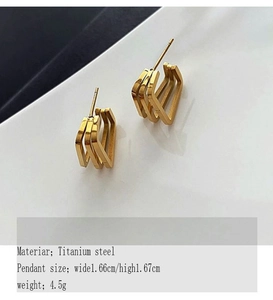 Macro shot of gold-plated titanium steel earrings with triple-layered geometric design