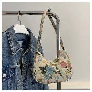 Macro shot of beige woven fabric tote bag with vintage floral patterns and gold buckle