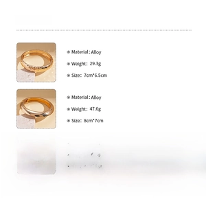 Detail view of gold alloy cuff bracelets with hammered and polished finishes and specs