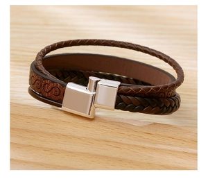 Detail of multi-layer brown leather bracelet with alloy magnetic clasp and embossed pattern