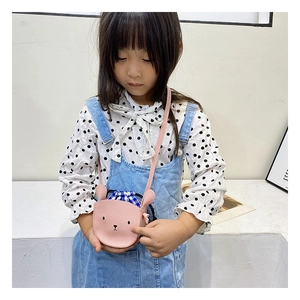 Detailed view of pink rabbit crossbody bag with embroidery and drawstring closure