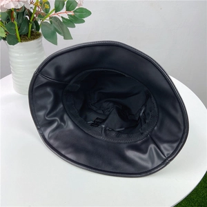 Detail of black leather bucket hat interior with adjustable drawstring and inner lining