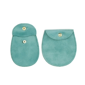 Detail of teal velvet jewelry pouch with gold snap button, open and closed view