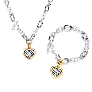 Detail view of twisted cable necklace and bracelet set with heart-shaped pendants