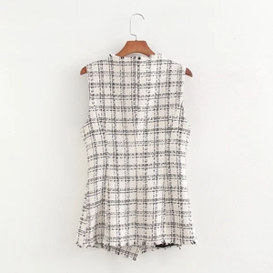 Detailed back view of white and black tweed vest featuring frayed edges and textured fabric