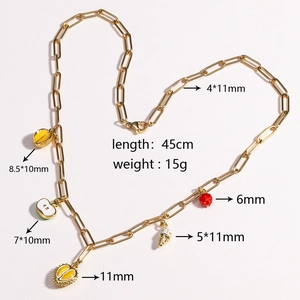 Golden paperclip chain necklace featuring five tropical fruit pendants on a clean backdrop