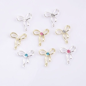 Hollow alloy bowknot nail art accessories with colorful rhinestones in gold and silver