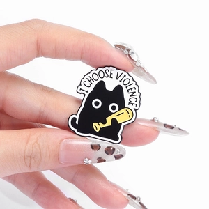 Funny black cat enamel pin with I CHOOSE VIOLENCE text holding a yellow bat on white background