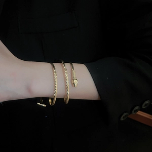 Detailed view of the golden snake spiral bracelet featuring intricate scale texture