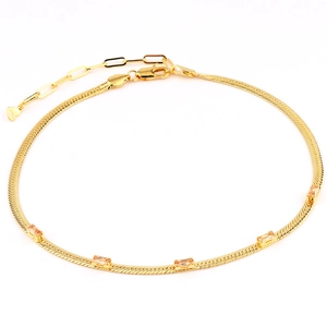 Detail of 18k gold plated snake chain anklet with four sparkling champagne zircons