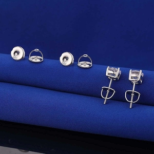 Macro shot of 925 sterling silver ear studs with square-cut gems and hallmarks