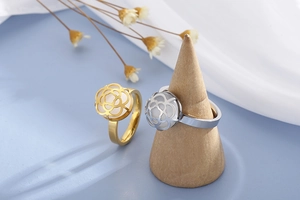 Detailed view of hollow rose gold and silver rings featuring moonstone floral accents