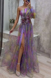 Close-up of one-shoulder mesh dress with gradient purple tones and feather floral decor