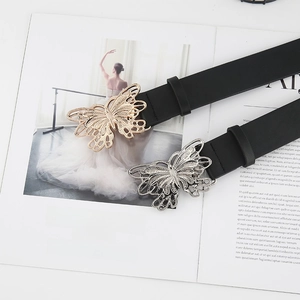 Detail of vintage butterfly buckle belt for women over an elegant magazine background