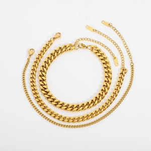 Three-piece layered gold Cuban link chains in varying widths with K18 material tags
