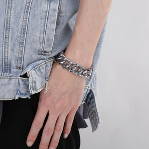 Macro view of vintage silver skull bracelet links with polished stainless steel finish