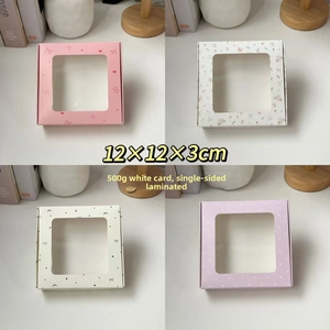 Detail view of four patterned square gift boxes with transparent windows 12x12x3cm