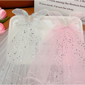 Detail of princess bow veil hair clip with lace butterfly, silver sequins and faux pearls