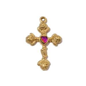 Macro detail of golden cross pendant with rose textures and an iridescent heart center