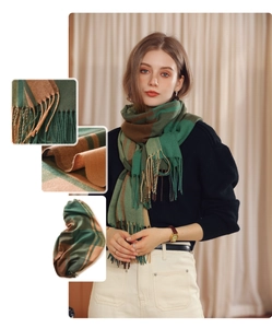 Close-up of green and brown plaid scarf featuring soft cashmere texture and tassel fringe