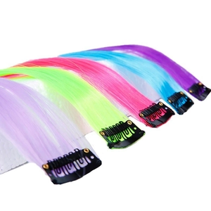 Detail of colorful clip-in hair extensions with metal BB clips and vibrant gradients