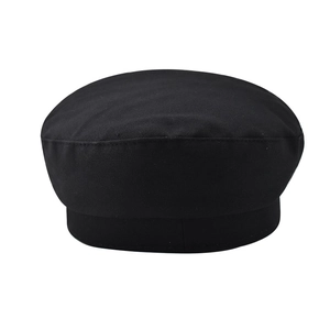 Close-up of a black baker boy hat showing twill cotton texture and structured brim