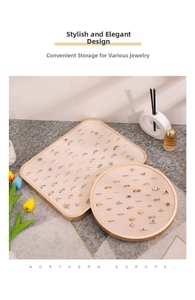 Macro view of beige velvet jewelry display trays with gold metal frames for rings