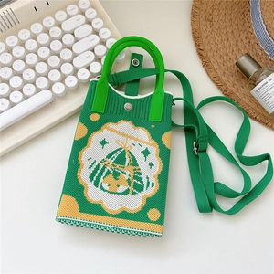 Detail of green knit phone bag with retro geometric pattern and adjustable strap