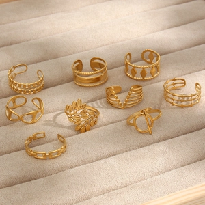 Set of 9 gold geometric open rings featuring chain and leaf designs on display