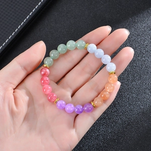Close-up of 8mm natural stone yoga beads bracelet with gold spacers on model wrist