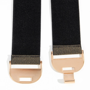Detail of woven straw belt ends with golden geometric buckles and reinforced stitching