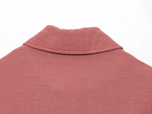 Detailed close-up of dark pink linen jacket showing neck stitching and fabric texture