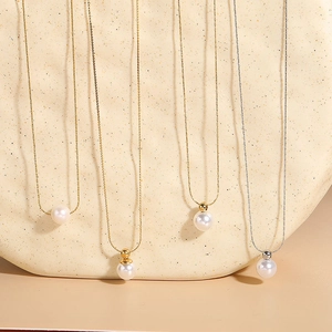 Detail view of minimalist titanium steel necklaces with elegant round white pearls