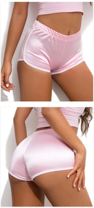 Front and back view of pink satin athletic shorts and top set with glossy finish