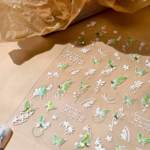 Frosted shell butterfly nail stickers with green floral patterns and rhinestone accents